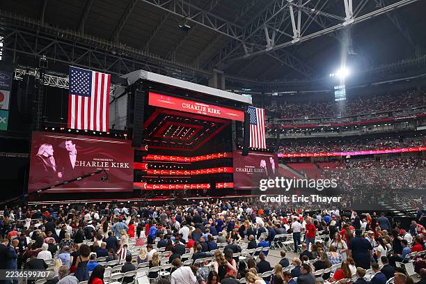 Attendees await the start of the memorial service for political activist Charlie Kirk at State Farm Stadium on September 21, 2025 in Glendale,...
