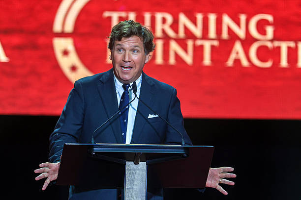 Political commentator Tucker Carlson speaks during the memorial service for political activist Charlie Kirk at State Farm Stadium on September 21,...