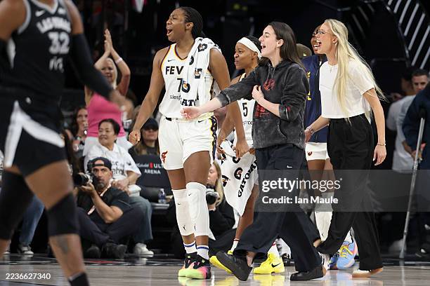 Aliyah Boston, Shey Peddy, Caitlin Clark, and Sophie Cunningham of the Indiana Fever cheer for their team against the Las Vegas Aces at end of the...