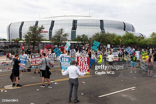 Protesters gather outside a public memorial service for right-wing activist Charlie Kirk at the State Farm Stadium on September 21, 2025 in Glendale,...