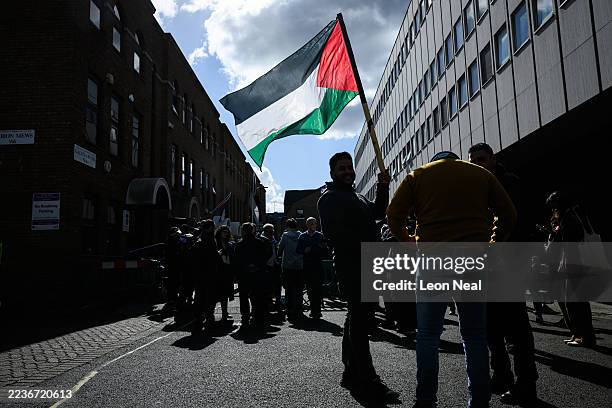Man holds a Palestinian flag outside the Palestine Mission to the UK following the flag-raising ceremony to mark UK's recognition of a Palestinian...