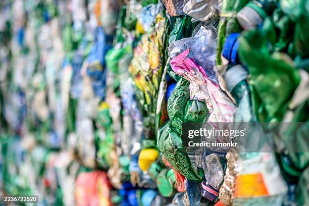 colorful bales of recycled materials in facility - circulaire economie stockfoto's en -beelden