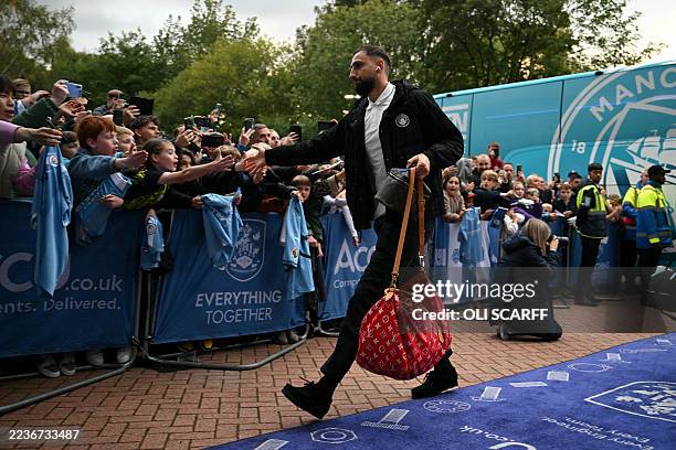 Manchester City's Italian goalkeeper Gianluigi Donnarumma arrives before the English League Cup third round football match between Huddersfield Town...