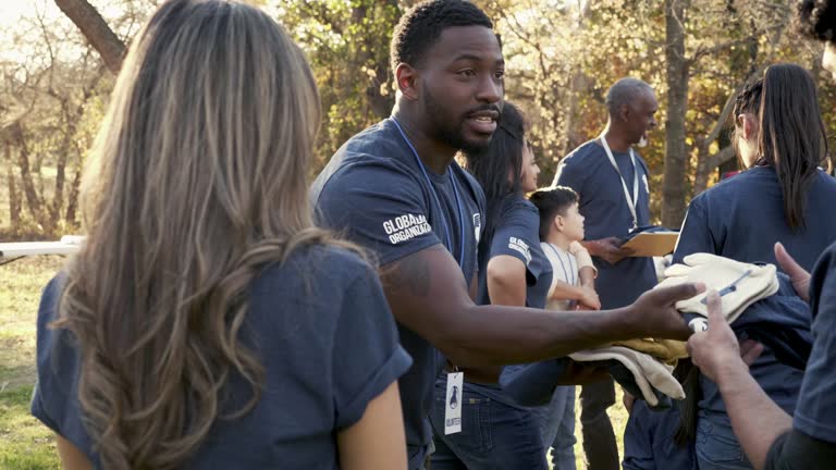 https://media.gettyimages.com/id/2236739456/video/volunteer-gives-a-man-and-woman-volunteering-t-shirts-and-work-gloves-during-cleanup-event.jpg?b=1&s=640x640&k=20&c=PxakyaOUJhmvfo3AaDxgL80zAJsH9gS4exyzManyHfQ=