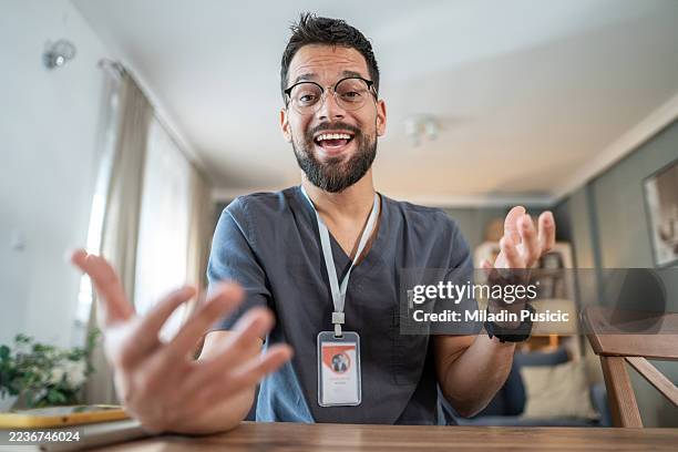 young male healthcare worker talking with joyful expression - doctor zoom stock pictures, royalty-free photos & images