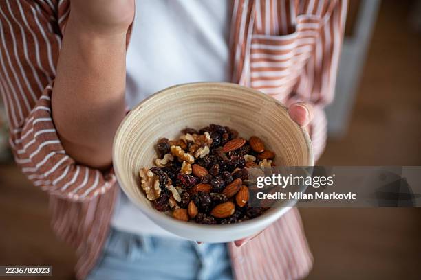 healthy lifestyle concept with mixed nuts and dried fruit snack bowl - trail mix stock pictures, royalty-free photos & images