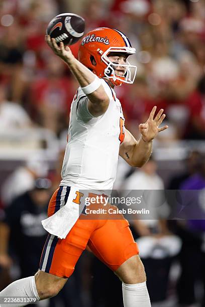Luke Altmyer of the Illinois Fighting Illini passes during the first half against the Indiana Hoosiers at Memorial Stadium on September 20, 2025 in...