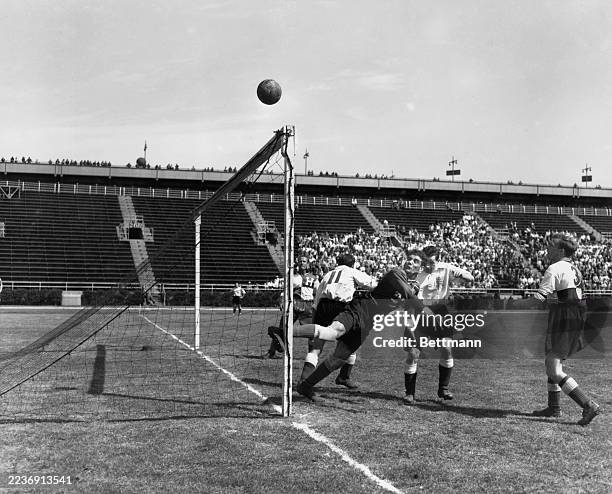 The USA team's goalkeeper Gino Gardassanich watches the ball after making a save in a friendly match against an English FA XI team at Triborough...