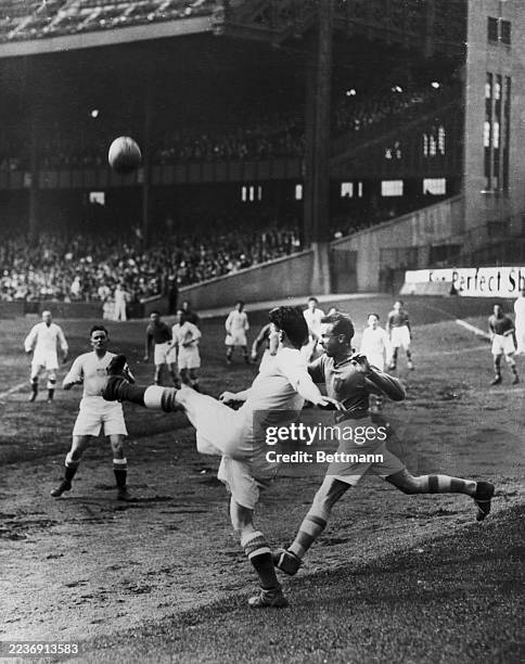 Jimmy Dwyer of the All-New York team kicking the ball just as Pat Phair of Irish champions Cavan catches up to him during a Gaelic football game at...