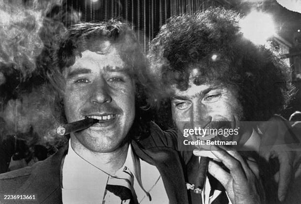 West German footballers Gerd Müller and Paul Breitner smoking cigars to celebrate their team's World Cup win in Munich, Germany, July 7th 1974. They...