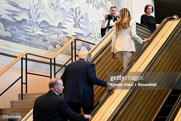 President Donald Trump and first lady Melania Trump walk up an escalator as they arrive to the 80th session of the UN’s General Assembly at the...