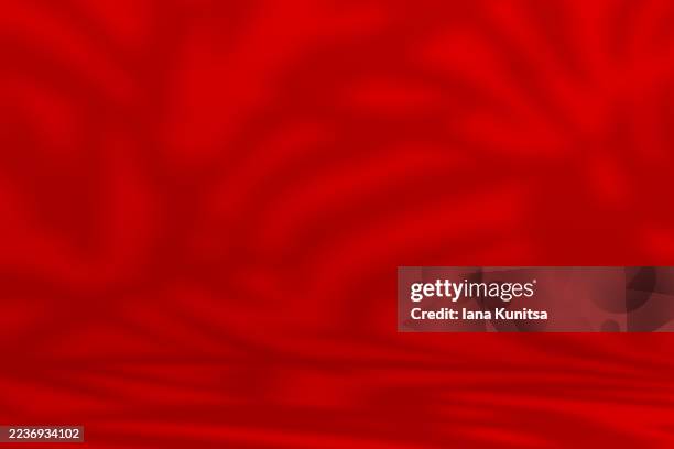 vibrant red abstract 3d background with smooth gradient waves and soft shadows. modern minimalistic texture ideal for creative design, festive themes, fashion, luxury branding, or artistic digital projects. - iluminación gobo fotografías e imágenes de stock