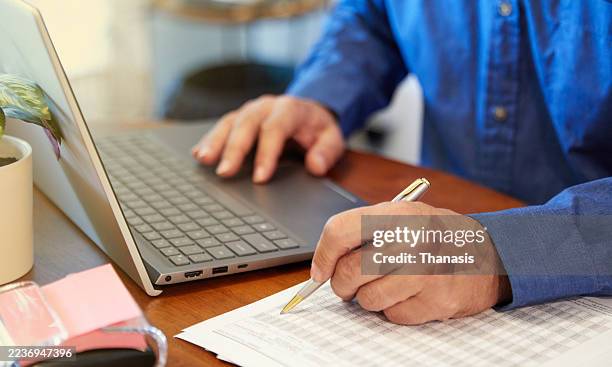 person filling out a document at a desk - form filling stock pictures, royalty-free photos & images