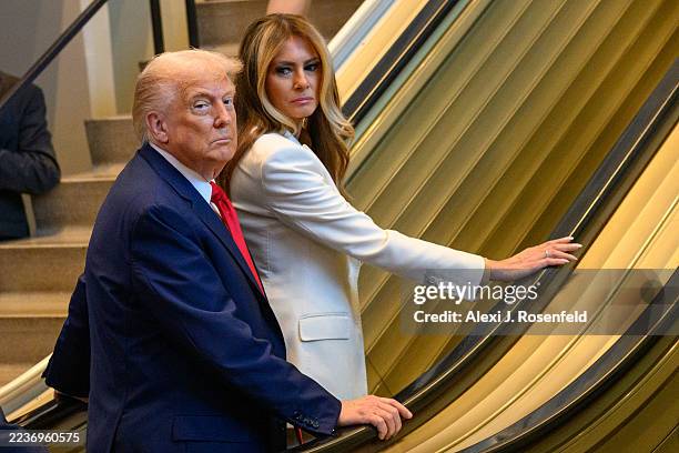 President Donald Trump and first lady Melania Trump step on an escalator as they arrive for the 80th session of the UN’s General Assembly on...