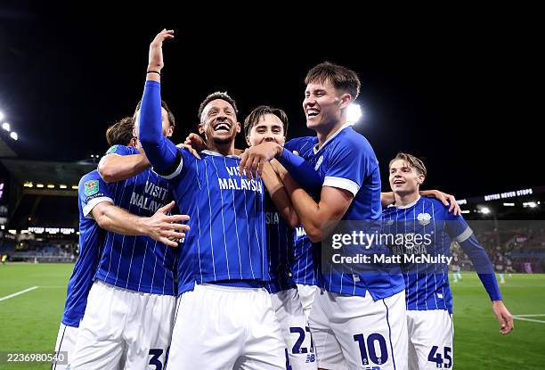 Callum Robinson of Cardiff City celebrates scoring his team's second goal with teammates during the Carabao Cup Third Round match between Burnley and...