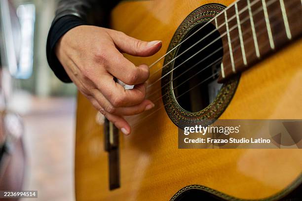 close-up of a musician playing acoustic guitar on a music studio - classical guitar stock pictures, royalty-free photos & images