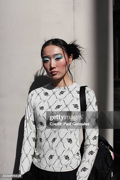 Model is seen wearing an ecru floral print top outside the Marques' Almeida show, during London Fashion Week on September 21, 2025 in London, England.