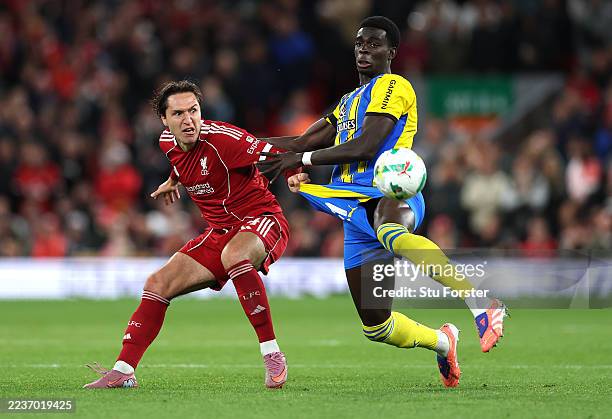 Federico Chiesa of Liverpool and Joshua Quarshie of Southampton compete for the ball during the Carabao Cup Third Round match between Liverpool and...