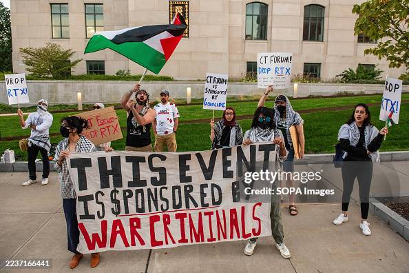 Pro Protesters Pro-Palestinian protesters hold a banner and placards during the ...