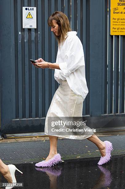 Guest wears pink fringed heels, creme white skirt, blouse outside Fendi during the Milan Fashion Week Womenswear Spring/Summer 2026 on September 24,...