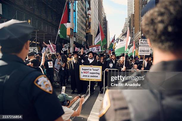 Hundreds of protesters gather in Times Square, chanting and holding signs to denounce Israel's military offensive in Gaza, as Israeli Prime Minister...