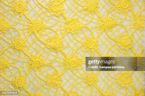 full frame shot of yellow embroidery lacy fabric - full body isolated photos et images de collection