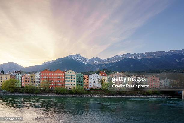 colorful riverside houses with alpine mountain backdrop - innsbruck stock pictures, royalty-free photos & images