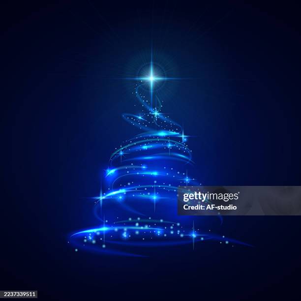 glowing abstract christmas tree with star on dark background - blue light source stock illustrations