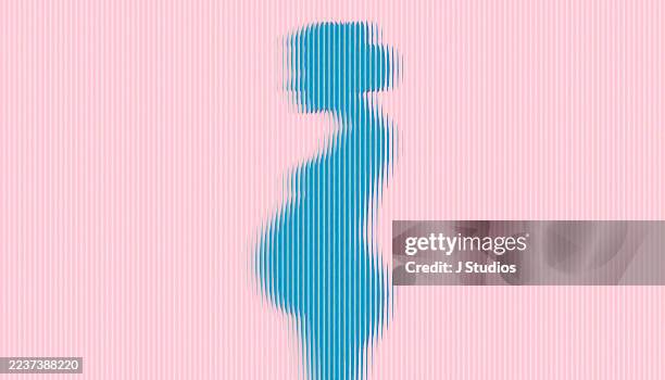 pink silhouette of pregnant woman behind reeded glass conceptual image - human fertility stock pictures, royalty-free photos & images
