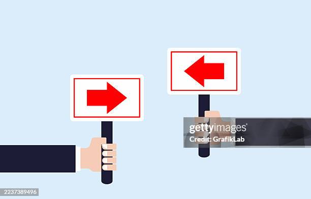 vector two hands holding signs indicating opposite directions with red arrows - logical thinking stock illustrations