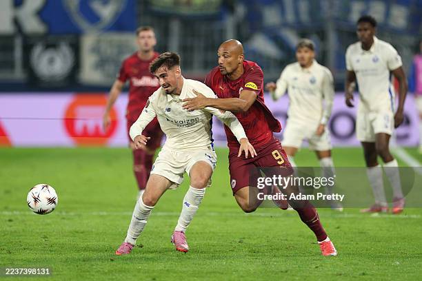 Martim Fernandes of FC Porto is challenged by Karim Onisiwo of Red Bull Salzburg during the UEFA Europa League 2025/26 League Phase MD1 match between...