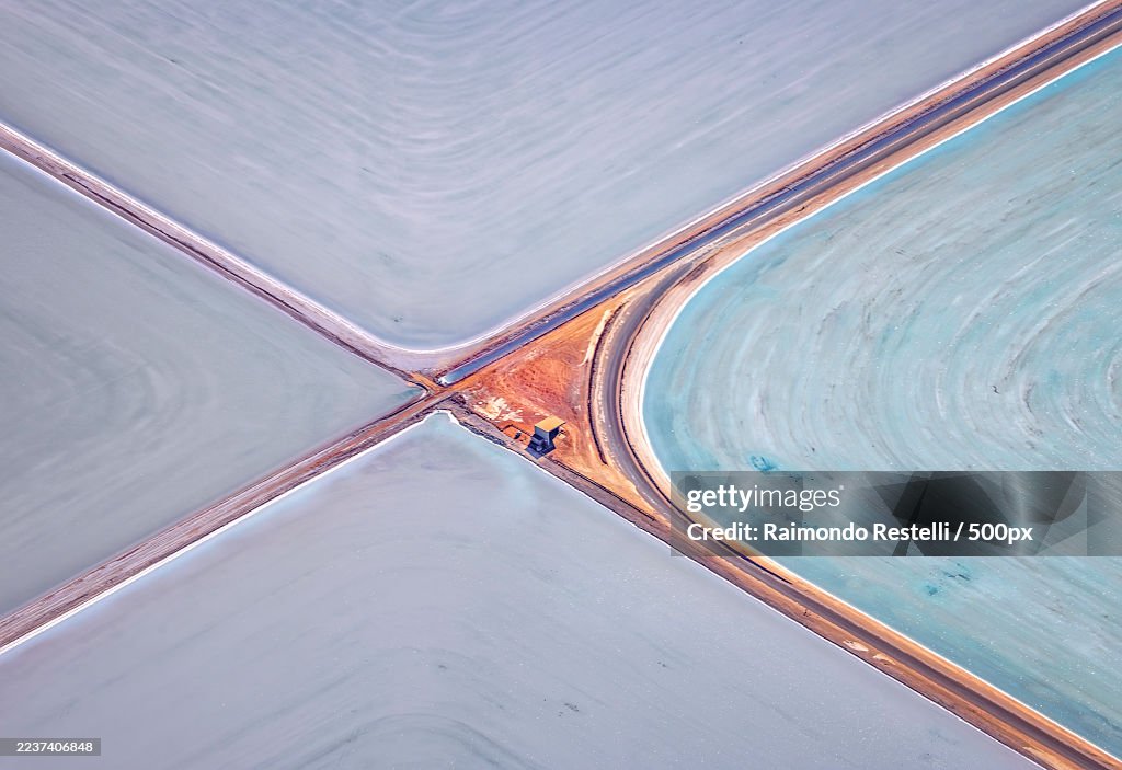 Aerial view of salt evaporation ponds with abstract patterns and vibrant colors