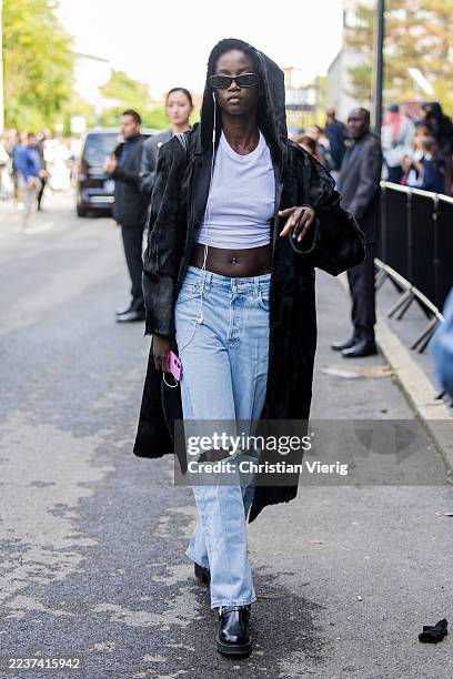 Model wears white cropped top, denim jeans outside Boss during the Milan Fashion Week Womenswear Spring/Summer 2026 on September 25, 2025 in Milan,...