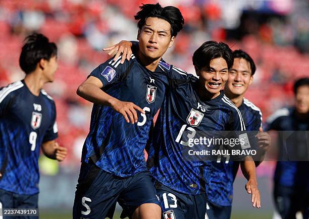 Japan's defender Rion Ichihara celebrates with teammate midfielder Hisatsugu Ishii after scoring a penalty kick during the 2025 FIFA World Cup U-20...