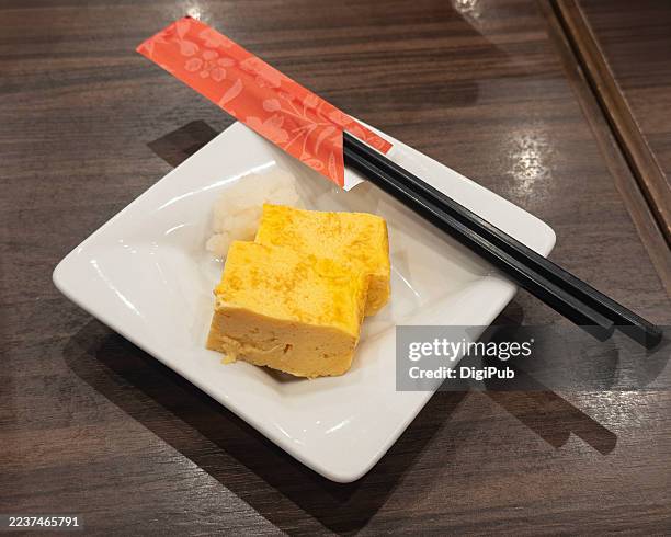 tamagoyaki with grated daikon and chopsticks - dashimaki tamago fotografías e imágenes de stock