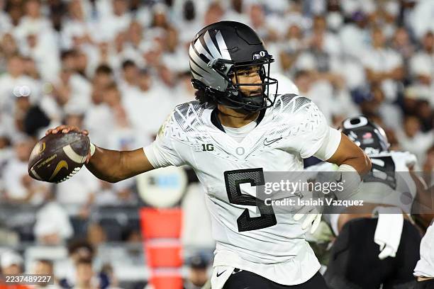 Dante Moore of the Oregon Ducks makes a throw during the second quarter against the Penn State Nittany Lions at Beaver Stadium on September 27, 2025...