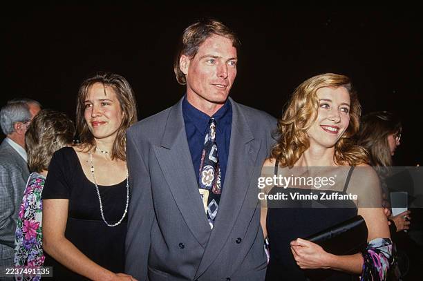 American actress and singer Dana Reeve, wearing a short-sleeve black outfit, and her husband, American actor Christopher Reeve, who wears a grey suit...