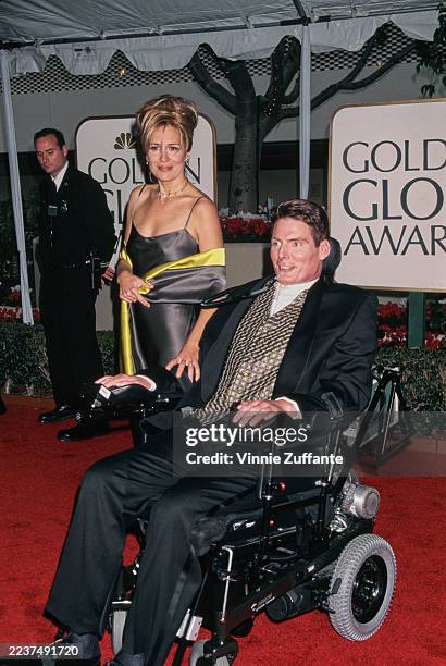 American actress and singer Dana Reeve, wearing a grey evening gown, and her husband, American actor Christopher Reeve, who wears a black suit over a...