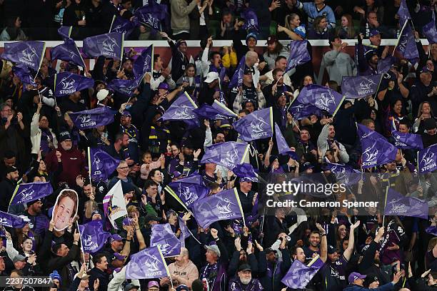 Storm fans show their support after a try during the NRL Preliminary Final match between the Melbourne Storm and Cronulla Sharks at AAMI Park on...