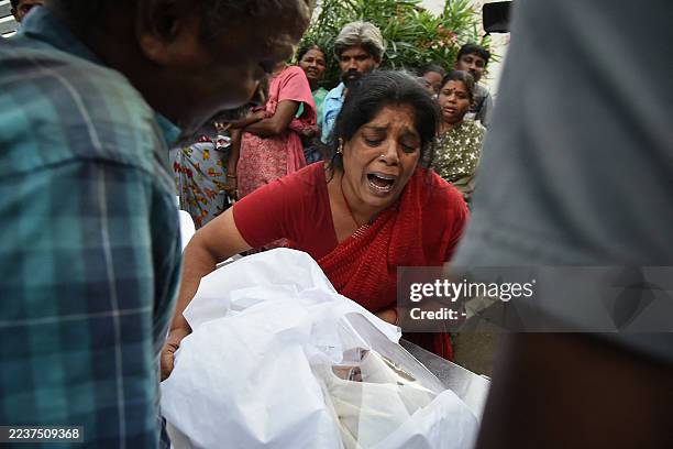 Graphic content / Relatives mourn after receiving the dead body of a victim who was killed in a stampede that broke out during a campaign rally last...
