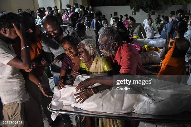 Relatives mourn after receiving the dead body of a victim who was killed in a stampede that broke out during a campaign rally last evening in the...