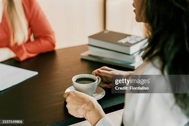 therapy session over coffee with therapist and client, collaborative conversation at a desk - world mental health day stock pictures, royalty-free photos & images
