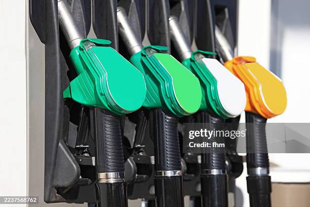 four taps on a petrol pump - bomba de combustible fotografías e imágenes de stock