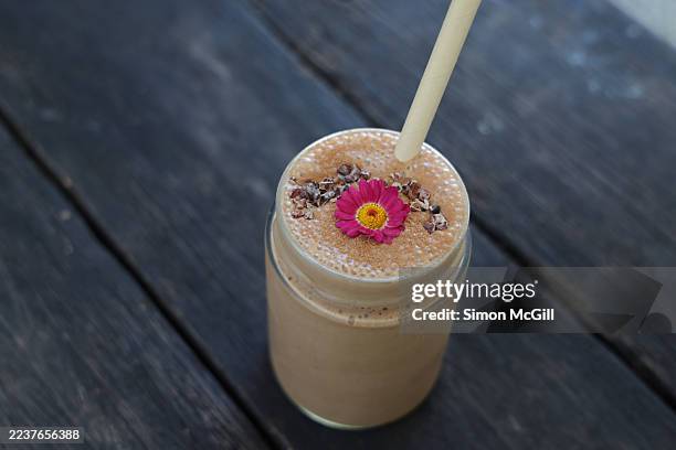 dairy-free smoothie with banana, peanut butter, cacao, dates, oat milk & cacao nibs - hafermilch stock-fotos und bilder