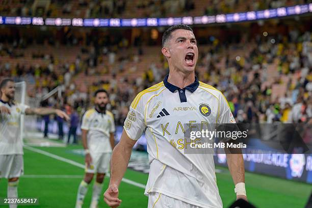 Cristiano Ronaldo of Al Nassr celebrates after scoring his teams second goal during the Saudi Pro League match between Al Ittihad and Al Nassr at...