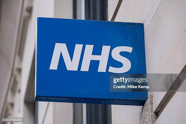 Sign for the NHS National Health Service outside a pharmacy on 4th August 2025 in London, United Kingdom.