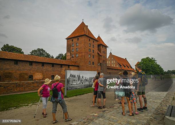 Group of tourists exploring Malbork Castle, in Malbork, Pomeranian Voivodeship, Poland, on September 3, 2025. Built in the 13th century by the...