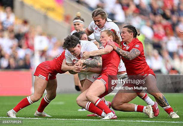 Taylor Perry and Alex Tessier of Canada stop Hannah Botterman of England from scoring a try during the Women's Rugby World Cup 2025 Final match...