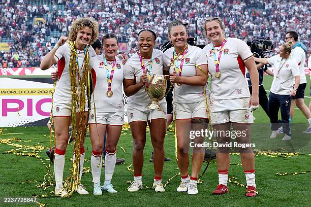 Ellie Kildunne, Lucy Packer, Sadia Kabeya, Maddie Feaunati and Morwenna Talling of England pose for a photograph with the Women's World Cup Trophy...