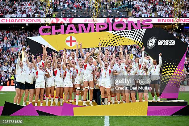 Zoe Aldcroft and Megan Jones of England lift the Women's Rugby World Cup trophy following victory in the Women's Rugby World Cup 2025 Final match...
